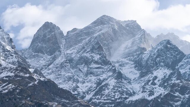 4K Time Lapse of clouds above snow covered mountain peaks at Sangla, Kinnaur District, India. Stormy weather in higher Himalayan mountain ranges. View of mountains during winter season.