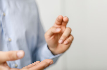 Close up shot of a person wearing a light blue shirt gesturing with their hands, perfect for...