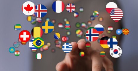 Concept image of a hand interacting with multiple international flags, representing global...