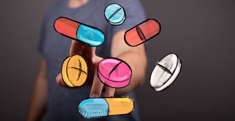 Image of a hand interacting with colorful pills and capsules, representing medicine, health, and treatment.