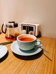 Freshly brewed tea on a wooden table in a cozy cafe setting