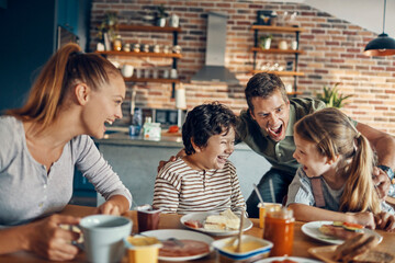 Happy family enjoying breakfast together