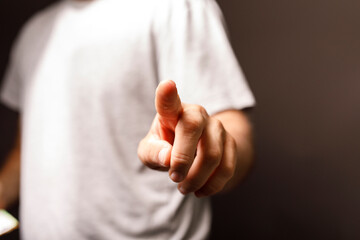 A close-up shot of a hand pointing towards the viewer, representing a decision, instruction, or call to action. Ideal for business, technology,