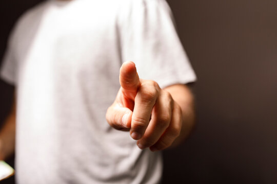 A close-up shot of a hand pointing towards the viewer, representing a decision, instruction, or call to action. Ideal for business, technology,