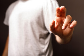 A close up shot of a hand making the crossed fingers gesture. Symbolizes luck, hope, or a gesture of faith. A versatile image for design and mes