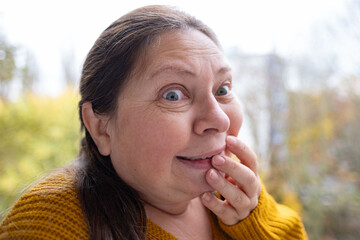 Astonished woman, Female face with silly expression and funny mimic, strong facial surprise and...