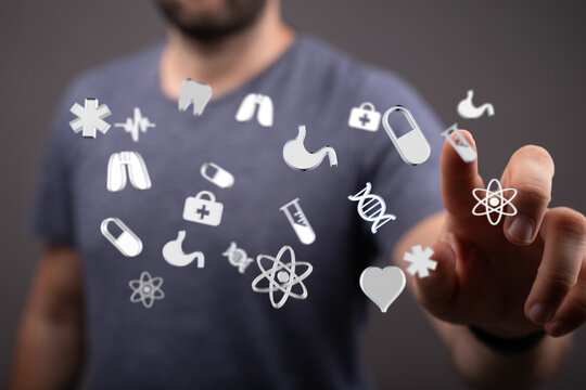 High-quality stock photo of a person interacting with a digital interface showing various medical icons. - Powered by Adobe