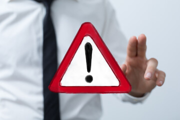 Image of a businessman presenting a warning alert sign.  Ideal for risk, caution, attention...