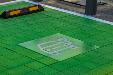 Electric vehicle parking space with green pavement marking