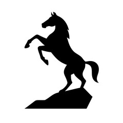 Silhouette of a rearing horse on a rock