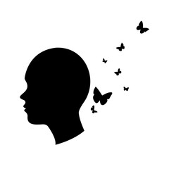 Silhouette of a head with butterflies flying away