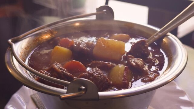 Hungarian Cuisine Concept. Traditional goulash meat soup close up. High quality 4k footage