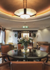 Elegant interior design furnishing bar lounge area onboard cruiseship cruise ship liner in Art Deco design with chairs, tables, bar counter and room dividers