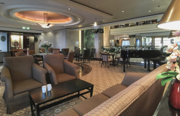 Elegant interior design furnishing bar lounge area onboard cruiseship cruise ship liner in Art Deco design with chairs, tables, bar counter and room dividers