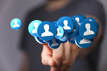 Hand holding a collection of people icons, representing connections, community, teamwork and social interaction. Ideal for business, marketing a