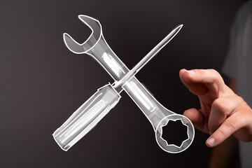 Hand interacting with digital tools,repair, service, maintenance concept.