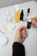 Woman with damaged nails is going to make manicure. Nail desk set up. White Manicure Table and accessories, supplies for nail care