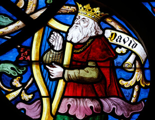 Saint Seine church.  Stained glass. The kingt David playing harp.  Corbigny. France.