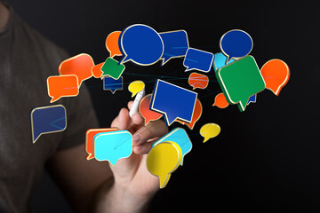 Concept of virtual communication using speech bubbles connected with lines in a dark setting. Concept of digital networking.