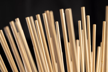 long sticks made of bamboo have a wide range of applications from cooking to use in agriculture.