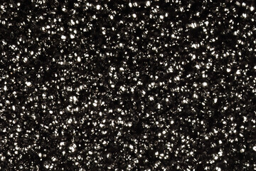 Shiny black beads in dense random pattern
