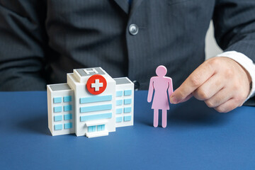 Women health. Female health and gynecology, including prevention, check-ups, care, symbolized by a visit to a doctor or medical facility. Hand holds a figure of a woman near the hospital building.