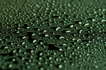 green wet surface covered with a large number of water droplets green surface