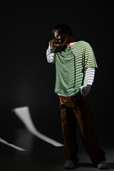 Stylish teenager poses in urban setting showcasing modern youth culture