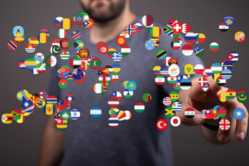 Image depicts a person interacting with floating flags of diverse nations, conveying themes of globalization, international cooperation, and cul