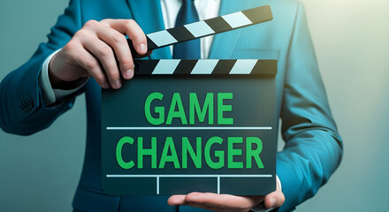 Businessman holds clapperboard announcing game changer