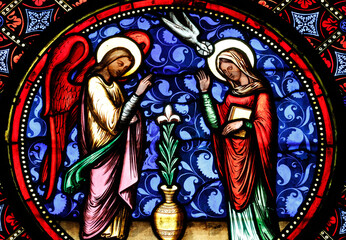 Fototapeta premium Bayeux cathedral. Stained glass. Stained glass window depicting the Annunciation, the moment when the Angel Gabriel announces to the Virgin Mary that she will conceive Jesus. Bayeux. France.