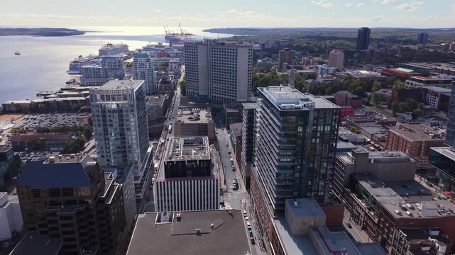 Aerial View Nova Scotia Capital Captured In Stunning Cinematic Style. Drone View Shows Downtown High-Rises, Calm Ocean Bay, And White Yachts Resting By The Marina In Fall.