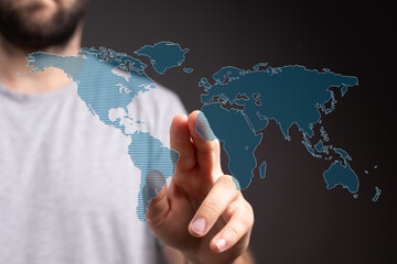 Man interacts with a digital world map, symbolizing global reach and connection.