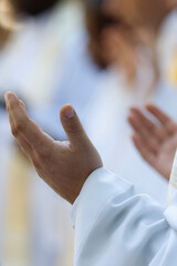 Fototapeta premium Catholic mass. Priest reciting the Our Father prayer. La Roche sur Foron. France.