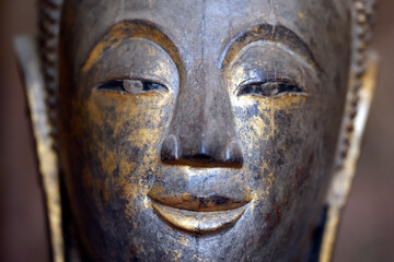 Wat Visounnarath buddhist temple. Wooden Buddha ( calling for the rain position ).  17 th - 18 th century. Wood, lacquer, gold leaf.  Luang Prabang. Laos. © Godong Photo