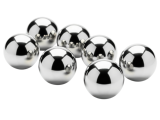 Many reflective chrome metal steel ball bearings are scattered on a transparent background