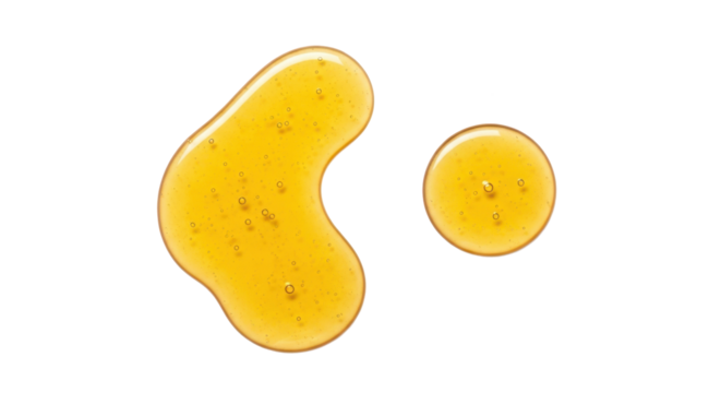 Two golden liquid gel blobs with tiny air bubbles glistening on a clear surface