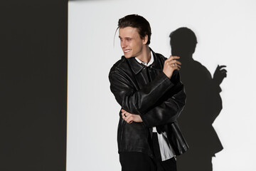 Stylish young man enjoys a moment of confidence while posing in urban setting