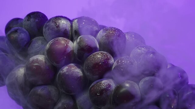 Macro Close-up of Fresh Purple Grapes with Water Droplets and Cold White Mist on Neon Purple Background, Luxury Fruit for Food Advertising