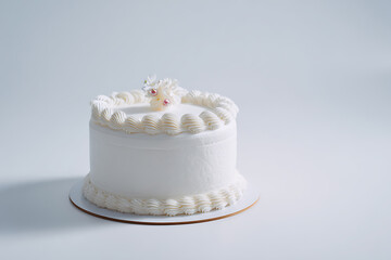 Elegant white cake with delicate floral decoration, perfect for a celebration or a special occasion.