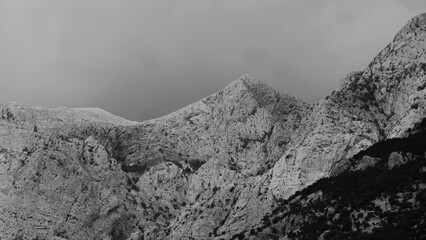 Big mountain high in the sky in misty clouds black and white