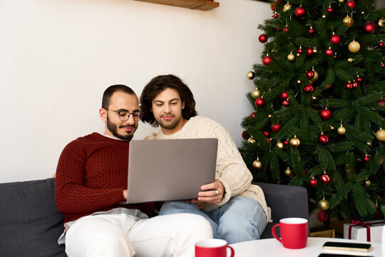 Loving couple shares festive moments while enjoying the holiday spirit at home - Powered by Adobe