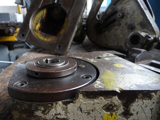 Close-up of worn industrial machinery parts with metal textures and aged paint