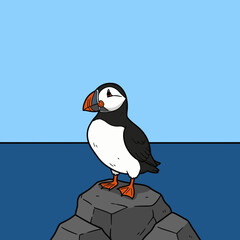 Naklejka premium A cartoon puffin bird stands perched on a grey stone, overlooking the water.
