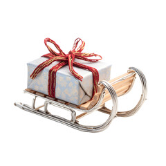 Miniature sleigh with gift, white isolated background