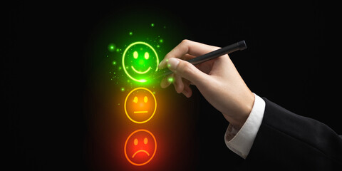 A hand selects a glowing green smiley face from a customer satisfaction scale, symbolizing positive...