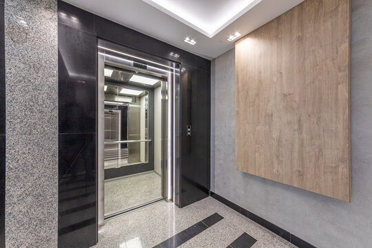 Modern elevator interior in contemporary building hallway. Luxury architecture, real estate, and office interior concept
