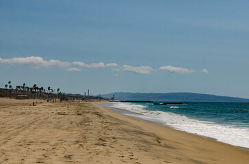 Los Angeles, California, sandy ocean shore, foaming waves rolling onto the beach