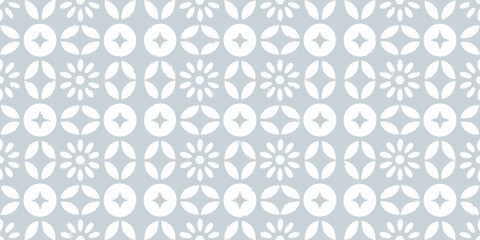 Seamless pattern of white geometric floral and star shapes on a light blue background