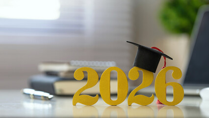 2026 concept with golden numbers and a mortarboard on a desk, blending New Year celebration with graduation symbolizing scholarships, academic success, and future goals for education marketing, Banner